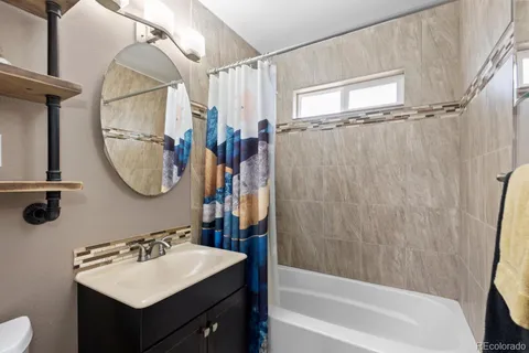 a bathroom with a sink vanity tub and a mirror