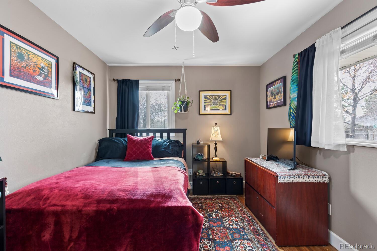 236 Lima Street Aurora, CO 80010 - Photo 24 of 50 a bedroom with a bed and wooden floor