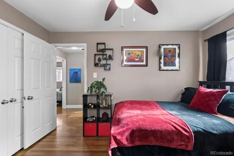 a bedroom with a bed a chandelier and dresser