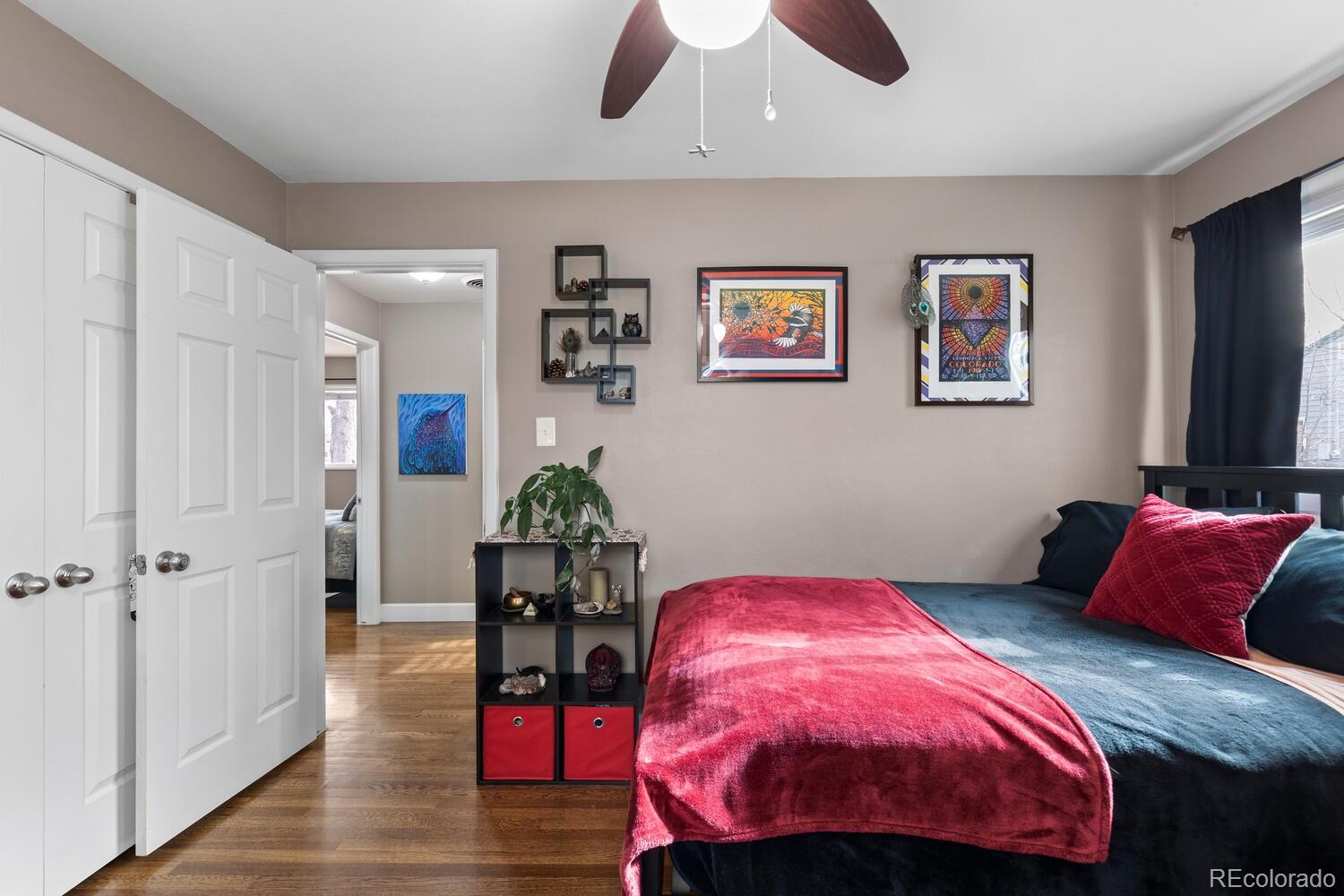 236 Lima Street Aurora, CO 80010 - Photo 25 of 50 a bedroom with a bed a chandelier and dresser