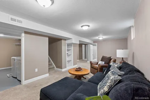 a living room with furniture and a rug