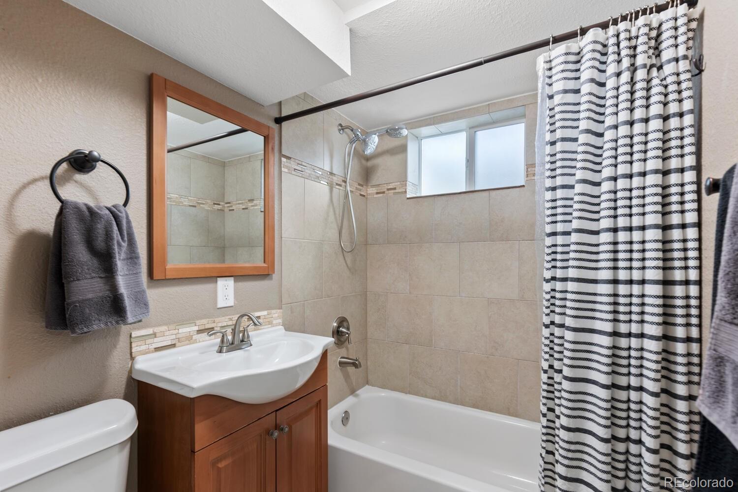 236 Lima Street Aurora, CO 80010 - Photo 36 of 50 a bathroom with a sink a toilet and shower