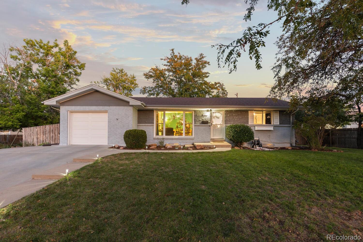 236 Lima Street Aurora, CO 80010 - Photo 43 of 50 a front view of a house with a garden and porch