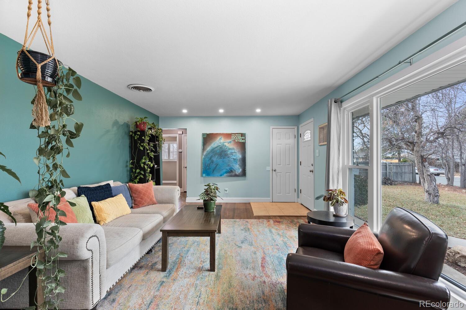 236 Lima Street Aurora, CO 80010 - Photo 5 of 50 a living room with furniture and a large window