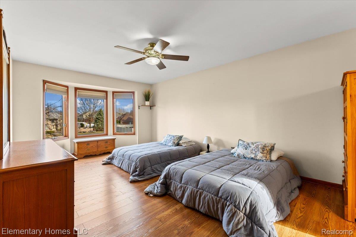 51637 Baker Road New Baltimore, MI 48047 - Photo 26 of 47 Bedroom featuring light wood-type flooring and ceiling fan