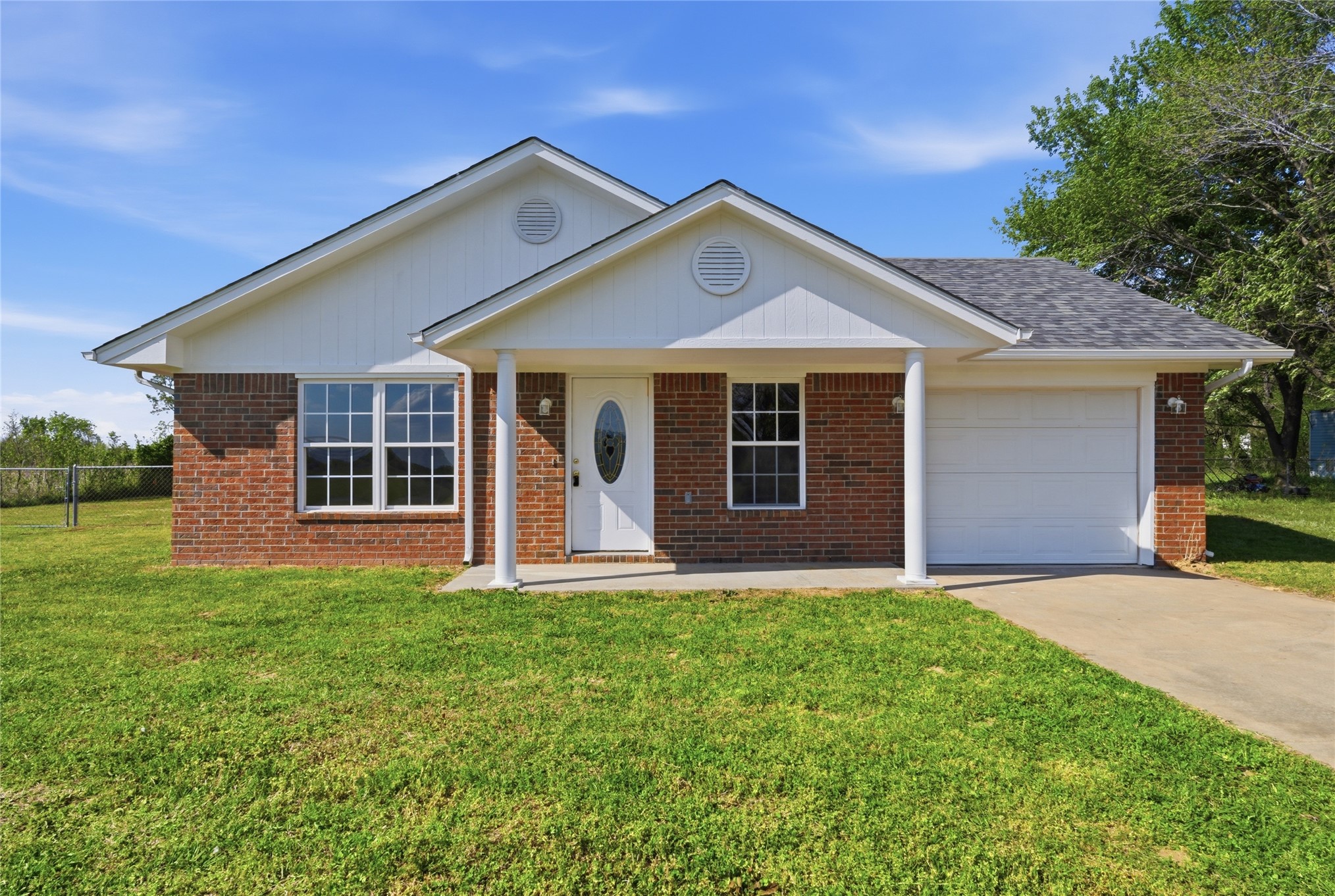 Brick exterior with white siding accents and a covered front entry