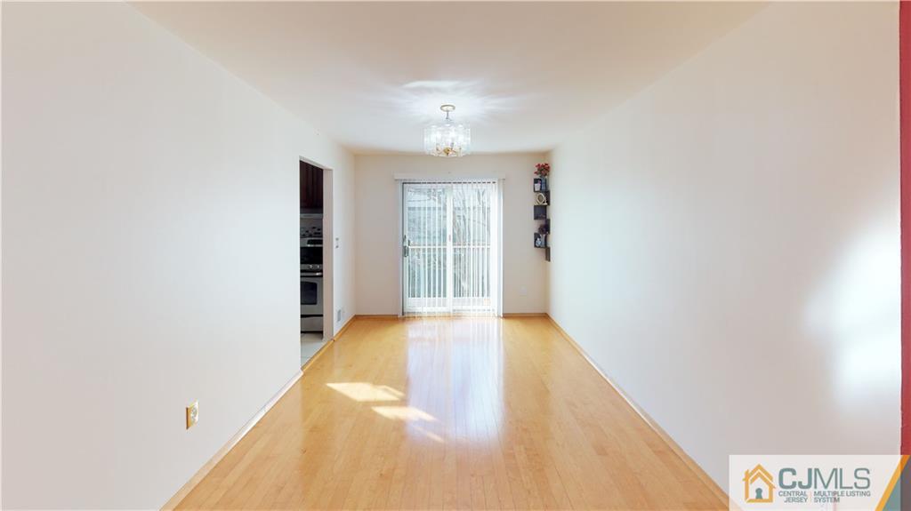 6905 Hana Road Edison, NJ 08817 - Photo 3 of 13 a view of an empty room with wooden floor