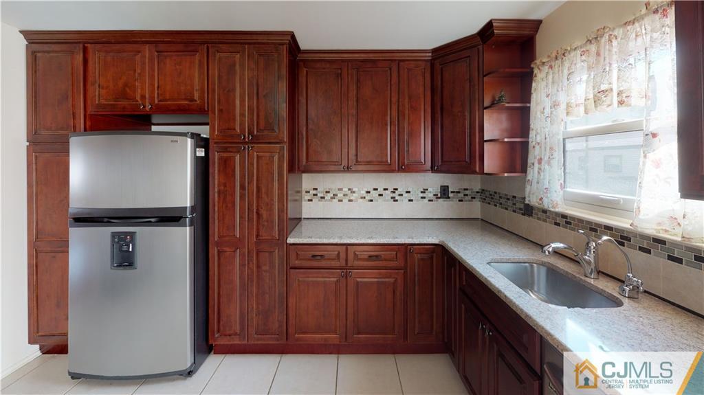 6905 Hana Road Edison, NJ 08817 - Photo 5 of 13 a kitchen with stainless steel appliances granite countertop a refrigerator and a sink