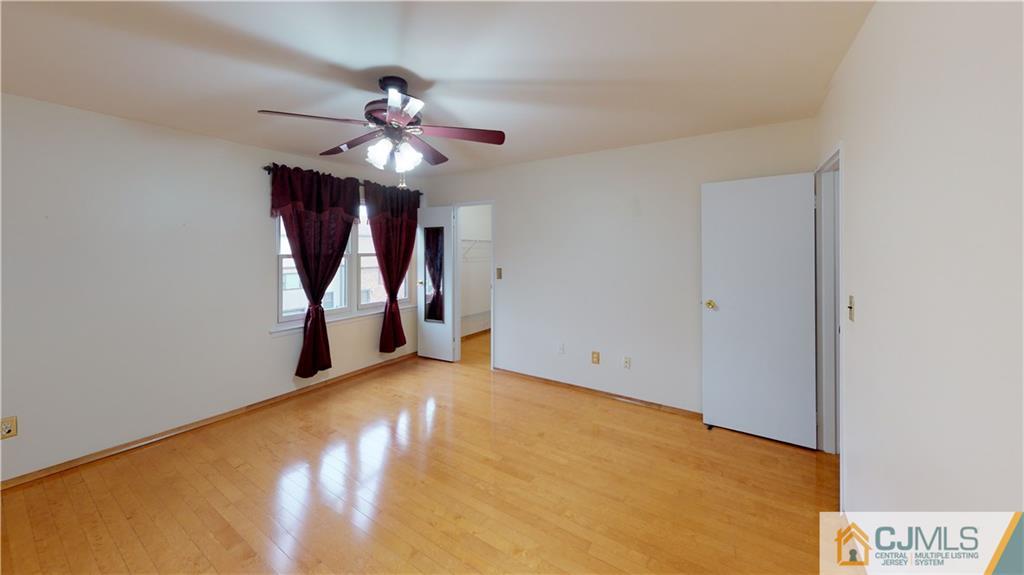 6905 Hana Road Edison, NJ 08817 - Photo 6 of 13 a view of an empty room with a chandelier fan