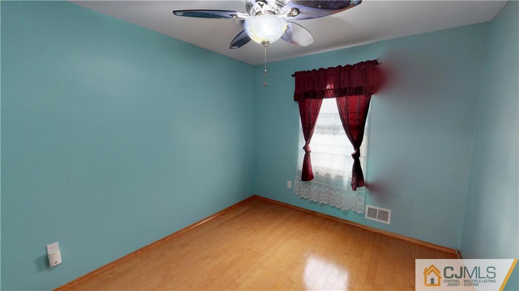 6905 Hana Road Edison, NJ 08817 - Photo 9 of 13 an empty room with windows