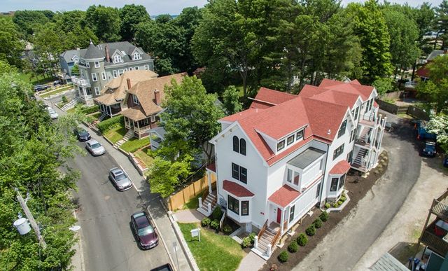 an aerial view of residential houses with outdoor space