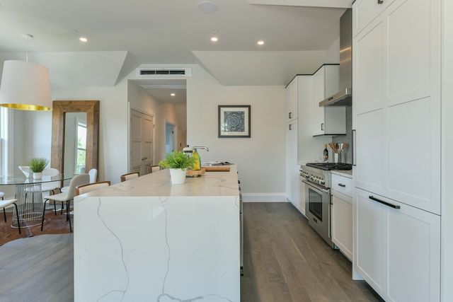 a large white kitchen with cabinets