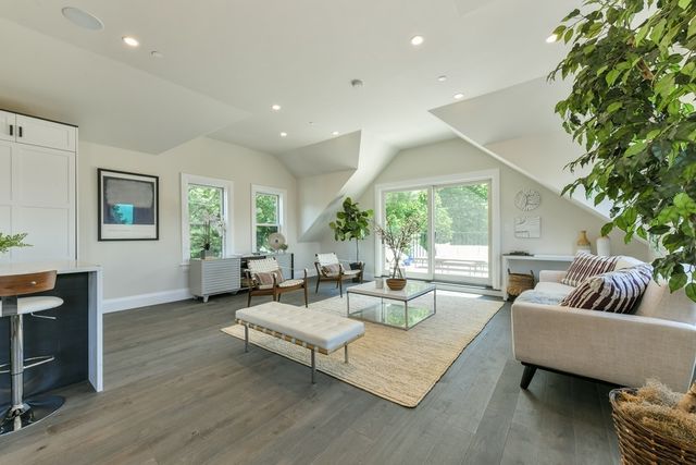 a living room with fireplace furniture and a large window