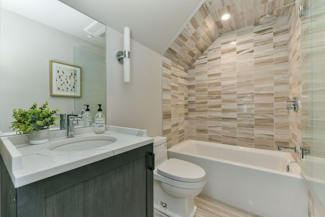 a bathroom with a sink a toilet and bathtub