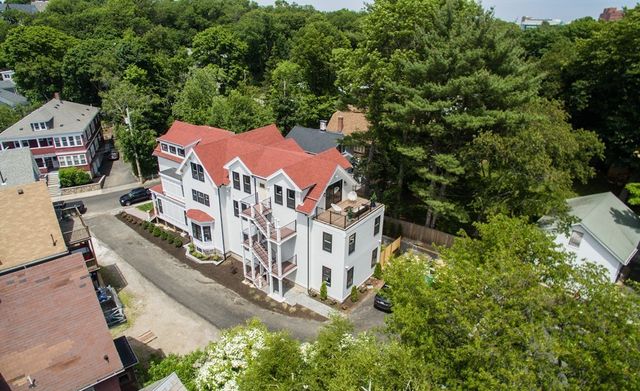 an aerial view of multiple houses with yard