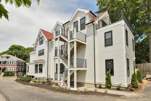 a view of a white house with a large windows