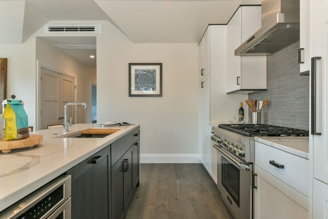 a kitchen with a sink stove and cabinets