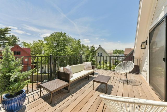 a view of balcony with wooden floor and outdoor seating