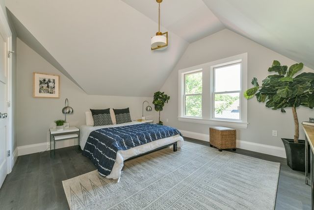 a spacious bedroom with a bed and a window