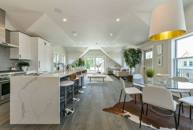 a living room with dining room and wooden floor