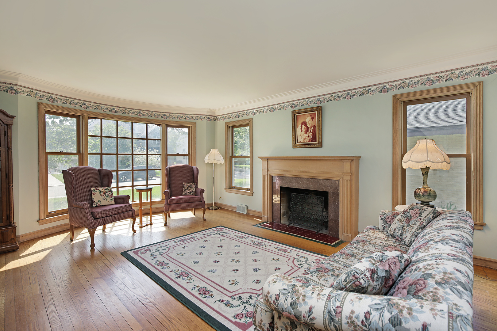 1158 Raleigh Road Glenview, IL 60025 - Photo 3 of 18 a living room with furniture a fireplace and a table