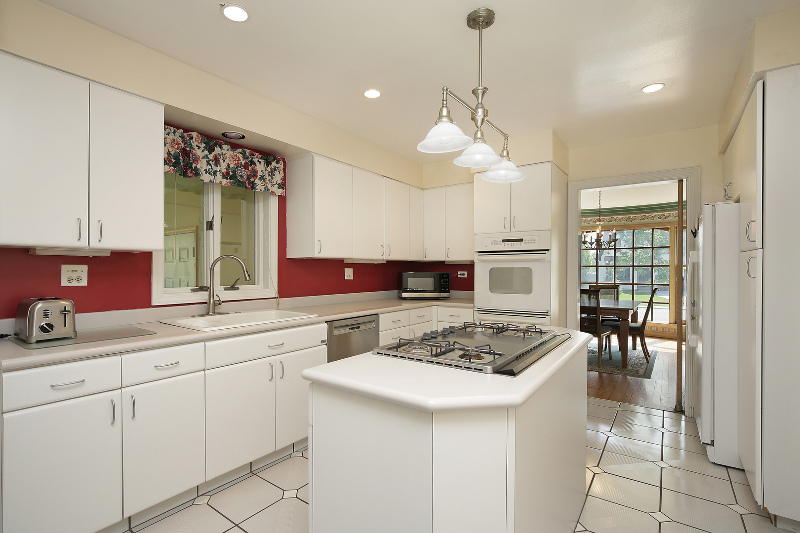 1158 Raleigh Road Glenview, IL 60025 - Photo 5 of 18 a kitchen with a sink a stove and chairs