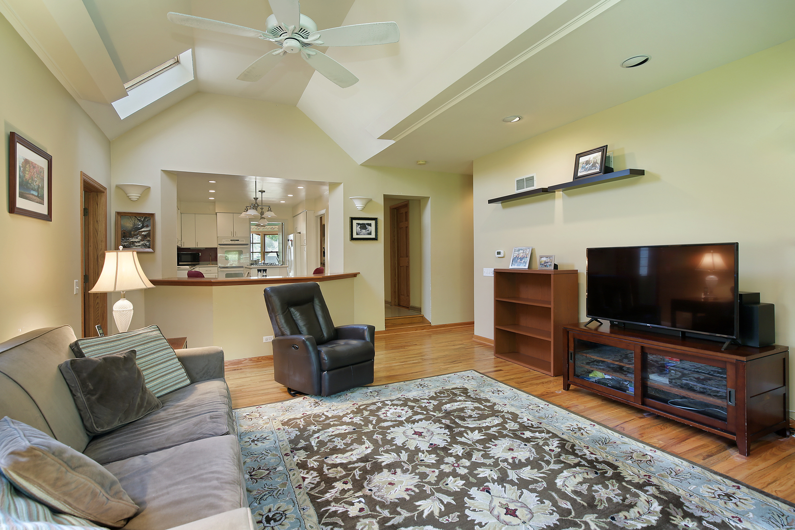 1158 Raleigh Road Glenview, IL 60025 - Photo 8 of 18 a living room with furniture and a flat screen tv