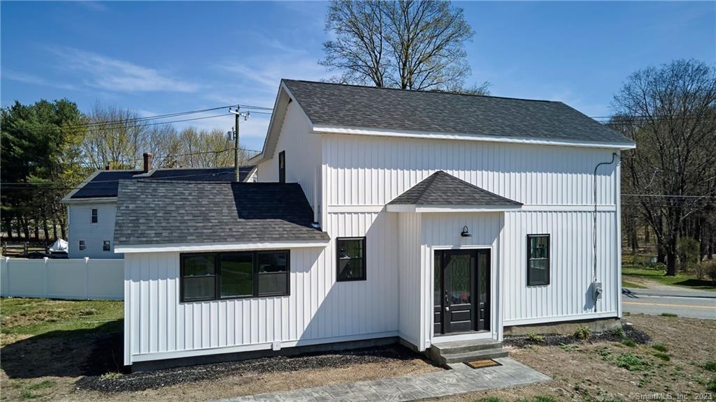 671 Wauregan Road Brooklyn, CT 06234 - Photo 1 of 1 a front view of a house with a garage