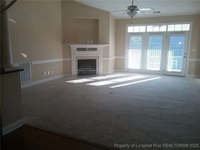 a view of empty room with a fireplace