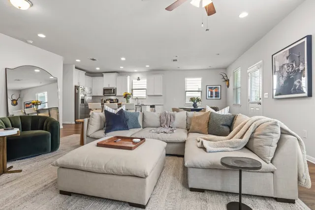 a living room with furniture and kitchen view