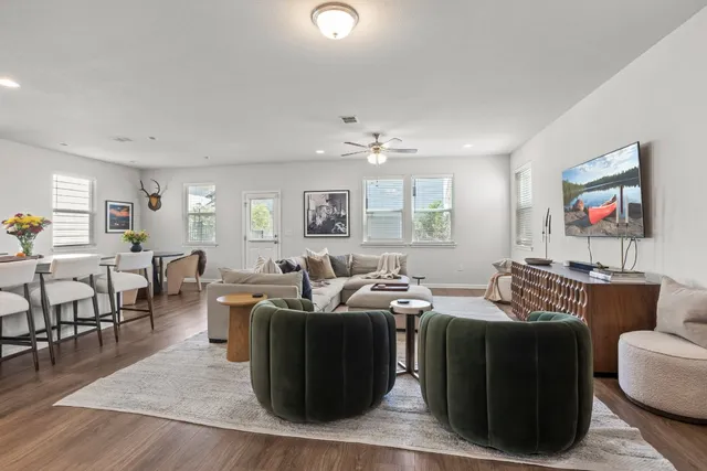 a living room with furniture and wooden floor