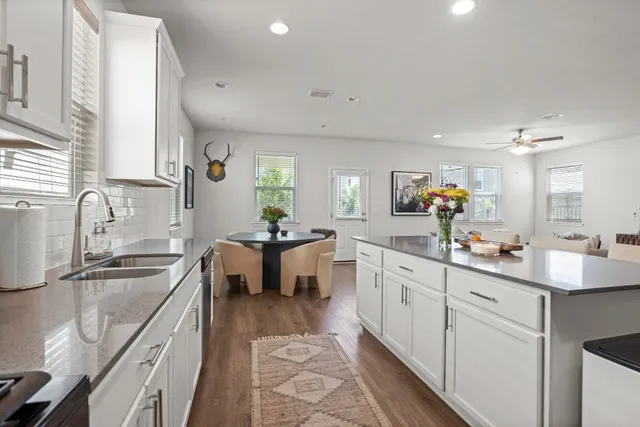 a kitchen with sink stove and cabinets
