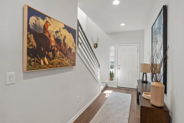 a view of a hallway with paintings on the wall