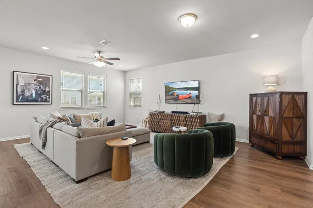 a living room with furniture and wooden floor
