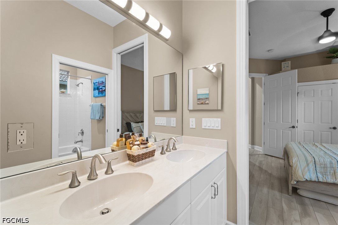 9042 Bronco Court Naples, FL 34113 - Photo 23 of 50 a bathroom with a sink and a mirror