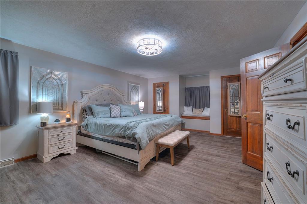 257 Arbor Hill Road Greensburg, PA 15601 - Photo 11 of 26 a spacious bedroom with a bed and a table in it