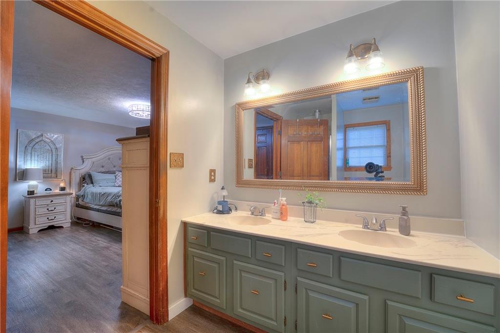 257 Arbor Hill Road Greensburg, PA 15601 - Photo 13 of 26 a en suite bathroom with a double vanity sink and a mirror