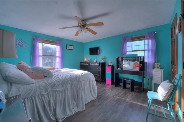 a bedroom with a bed and a chair