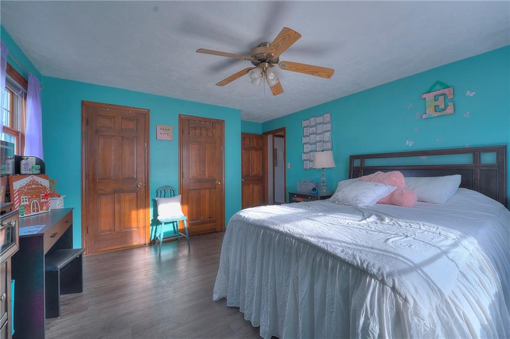 257 Arbor Hill Road Greensburg, PA 15601 - Photo 20 of 26 a bedroom with a bed and a chandelier