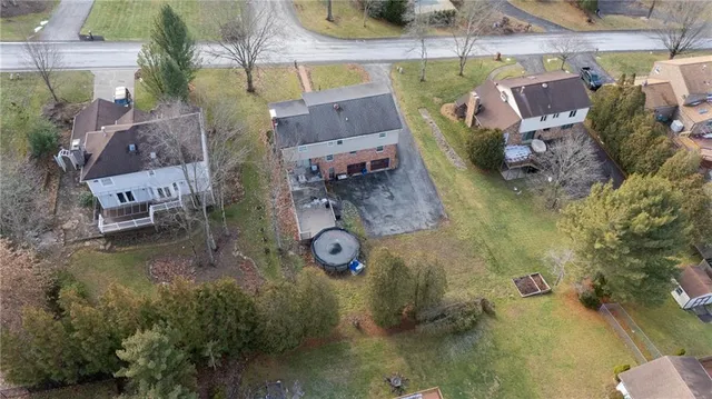 an aerial view of residential house with outdoor space and parking