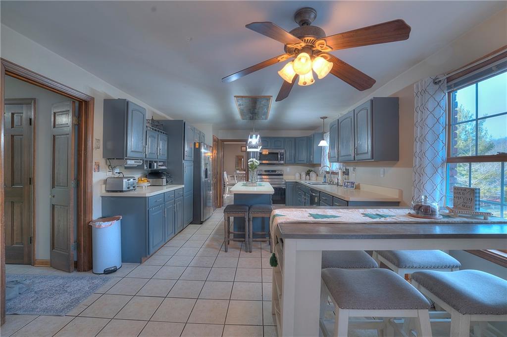 257 Arbor Hill Road Greensburg, PA 15601 - Photo 9 of 26 a kitchen with a table chairs refrigerator and cabinets