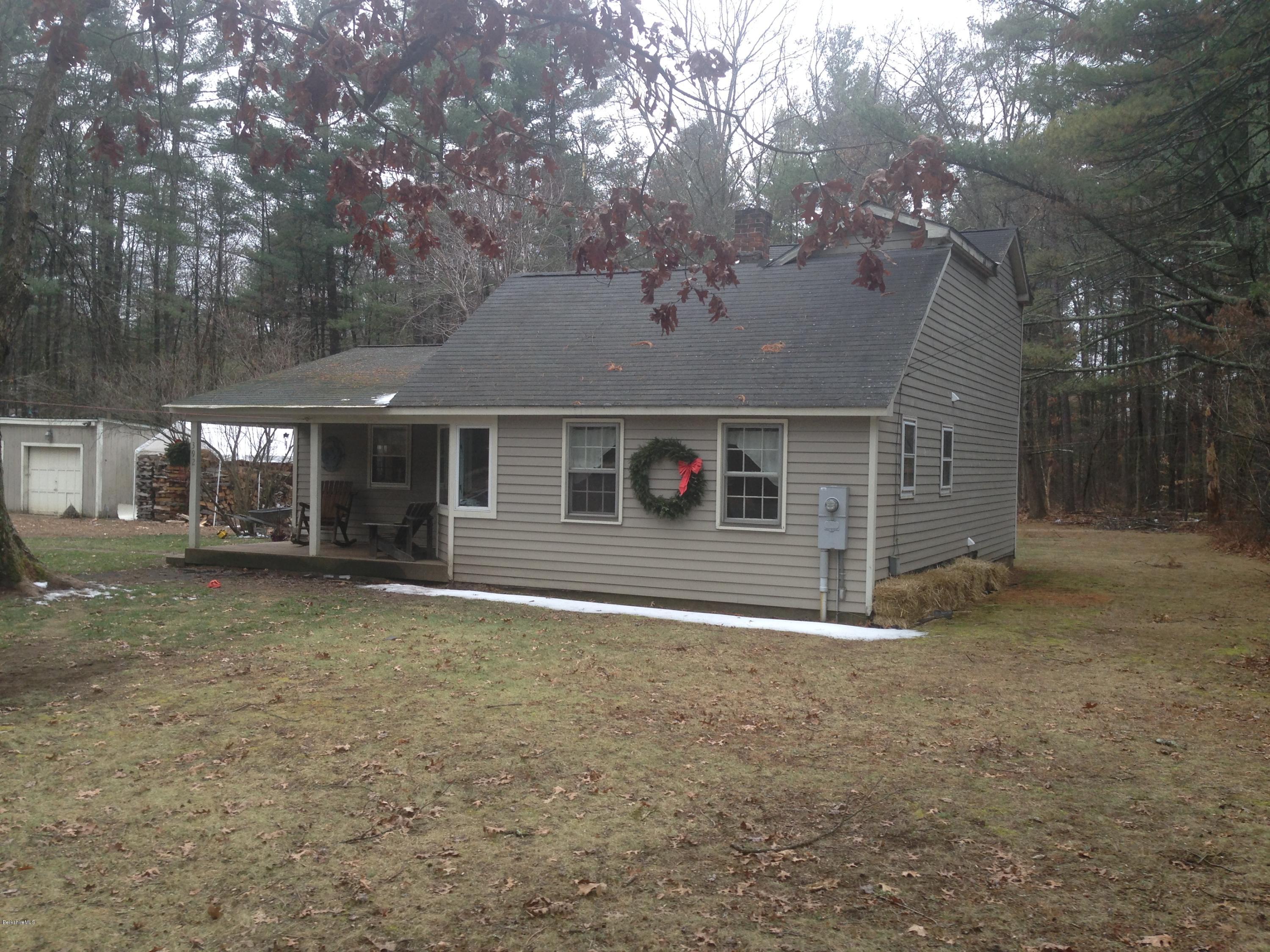 392 Polikoff Road Sheffield, MA 01222 - Photo 3 of 20 a front view of a house with a garden and trees