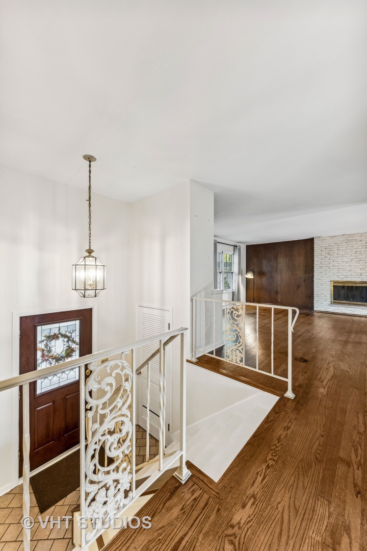 450 West Gartner Road Naperville, IL 60540 - Photo 8 of 31 a view of a livingroom with wooden floor and stairs
