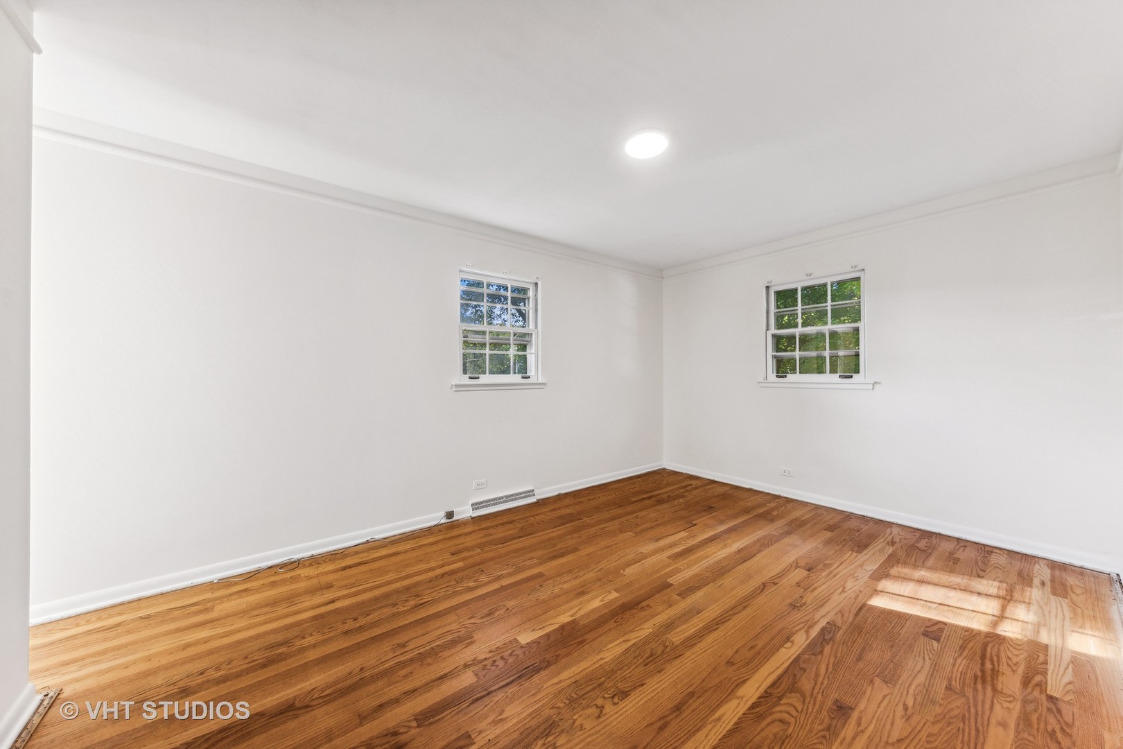 450 West Gartner Road Naperville, IL 60540 - Photo 10 of 31 an empty room with wooden floor and windows