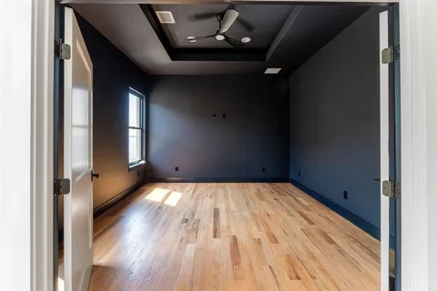 a view of empty room with wooden floor