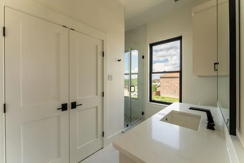 a bathroom with a tub a sink and a window
