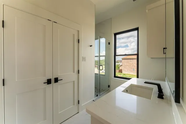 a bathroom with a tub a sink and a window
