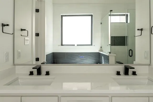 a bathroom with a tub sink and mirror