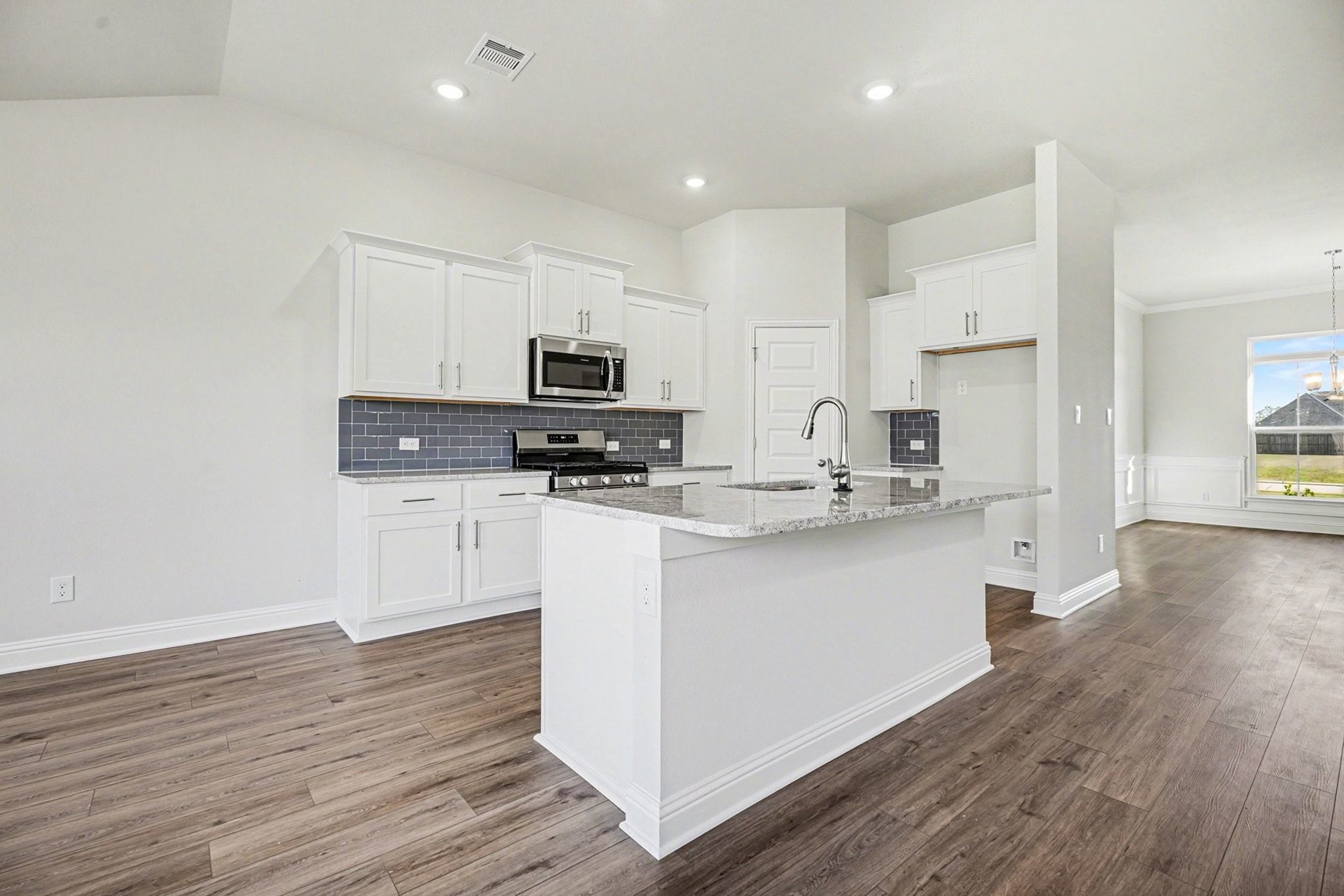 5 Keystone Court Angleton, TX 77515 - Photo 11 of 33 a kitchen with white cabinets and appliances
