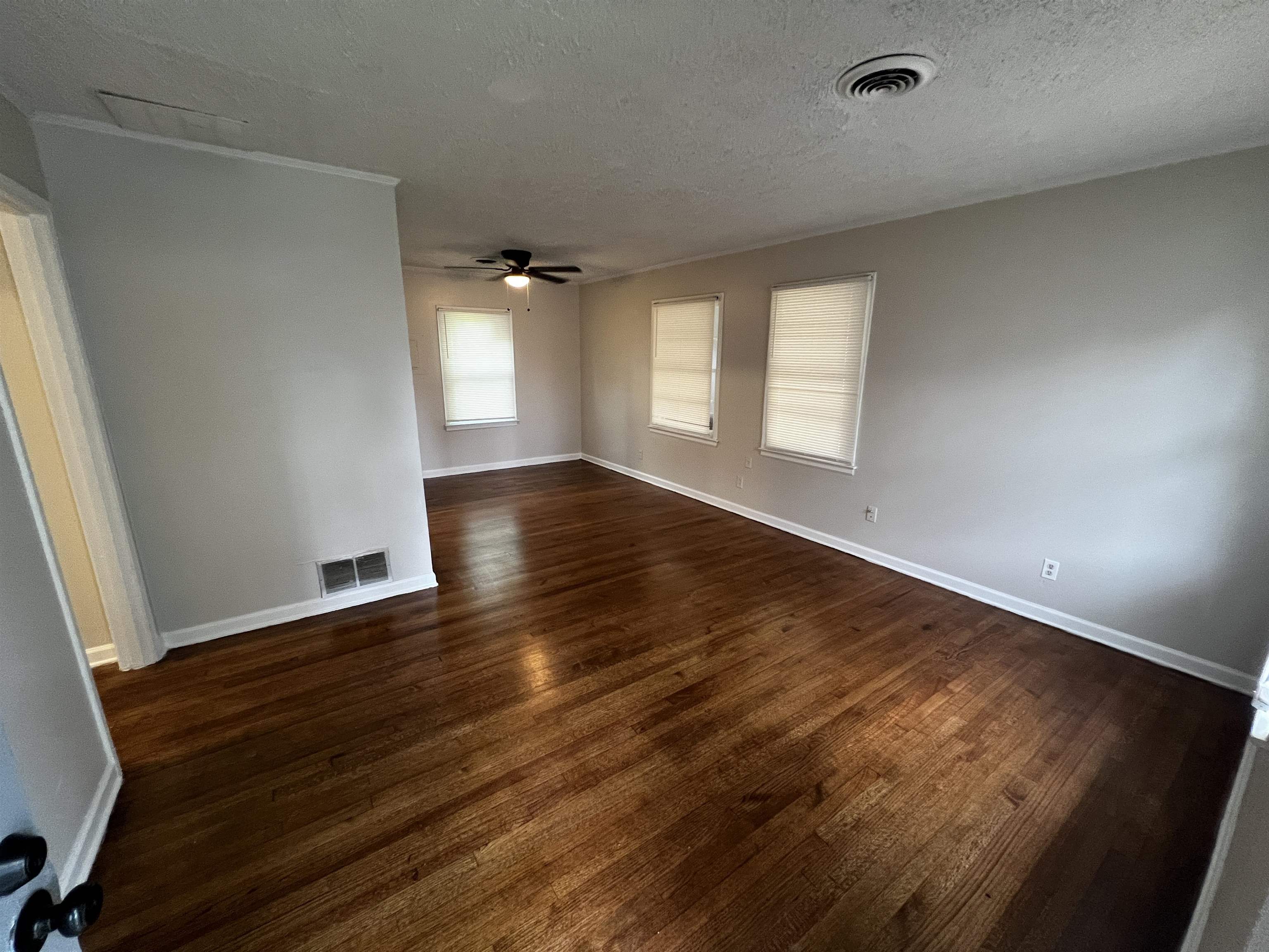 4801 Given Avenue Memphis, TN 38122 - Photo 4 of 13 an empty room with wooden floor and windows
